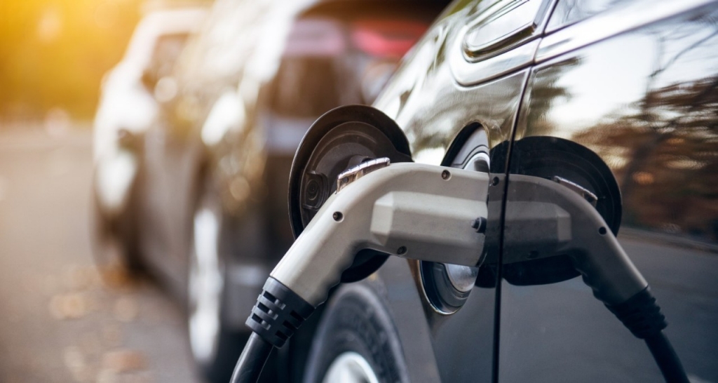Close up of an EV that plugged in and charging