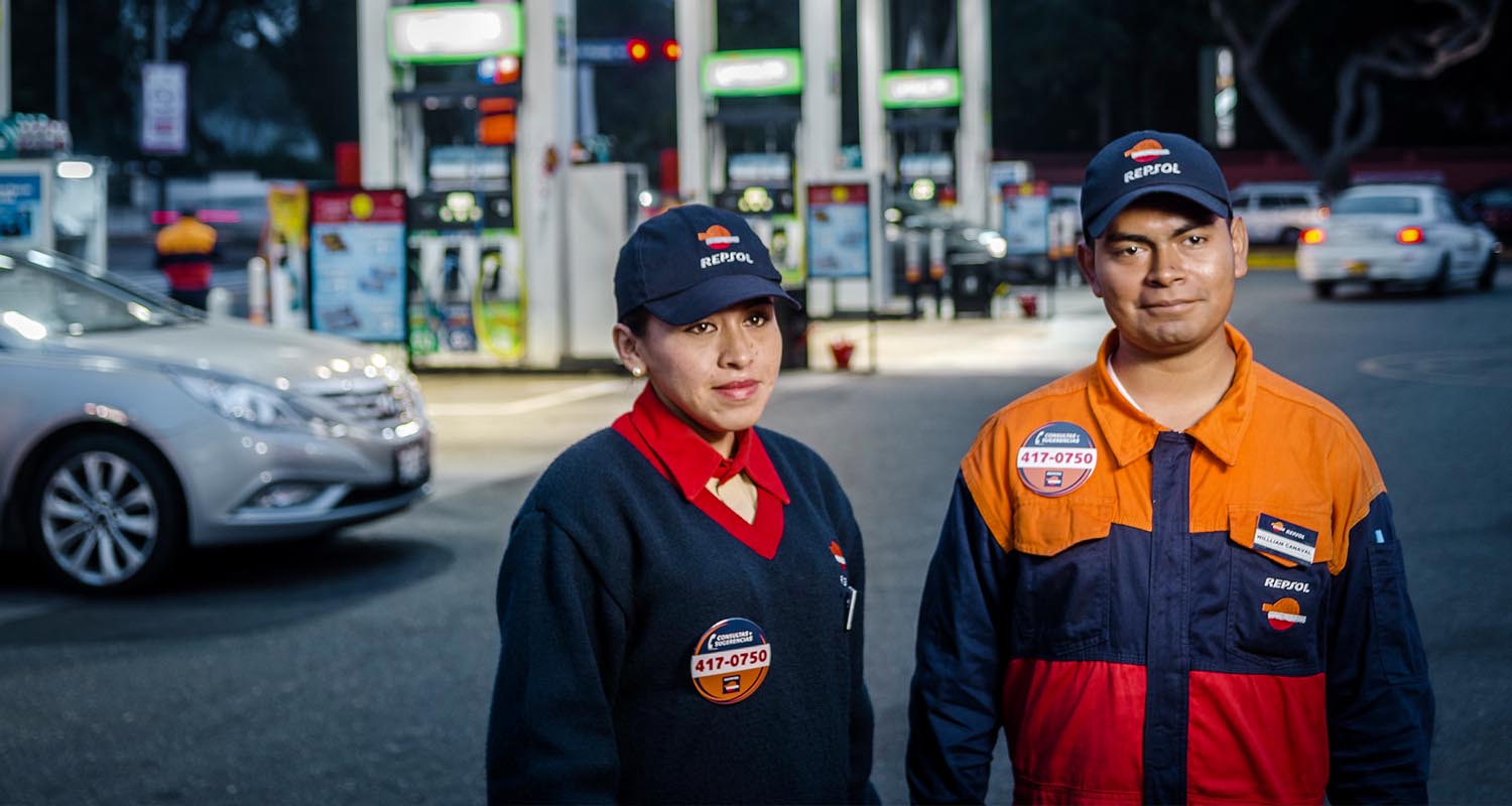 Employees posing next to a service station in Peru
