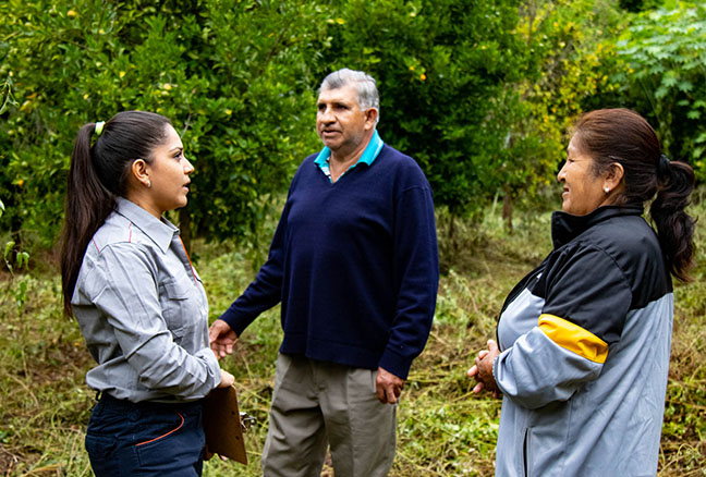 Repsol in Bolivia. Several people chatting on a plantation 