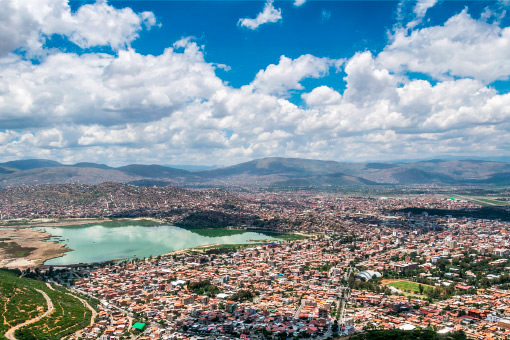 Repsol in Bolivia. Aerial view of a town beside a lake 