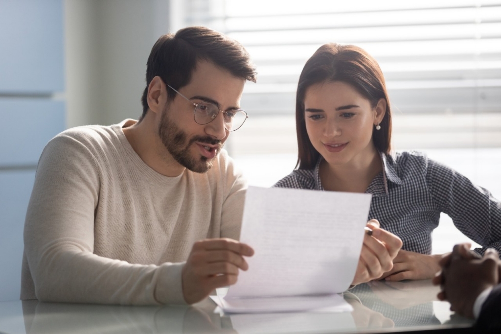 Two people looking at a file