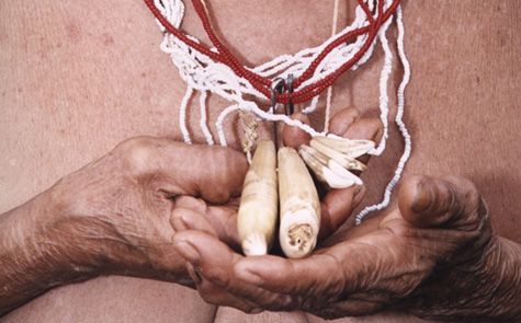 An upclose shot of a person holding a handmade necklace