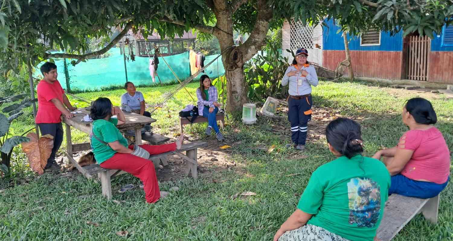 A Repsol empoloyee and others at a community monitoring activity.