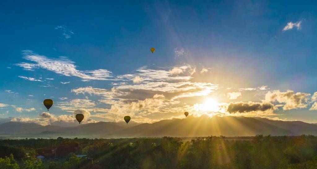 Hot air balloons flying over a landscape