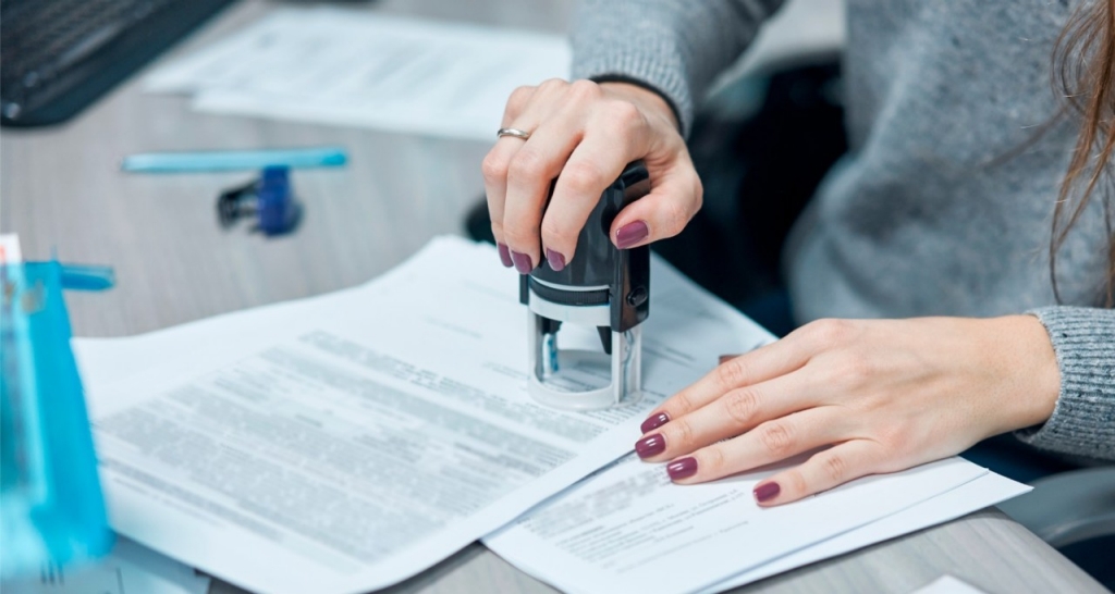 A person stamping a document