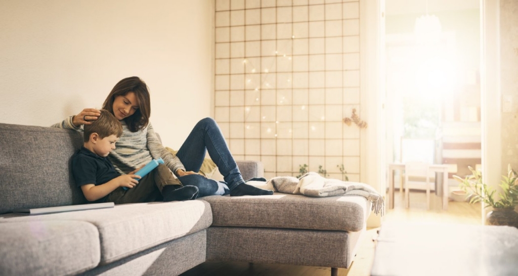 A woman and a child sitting on a couch