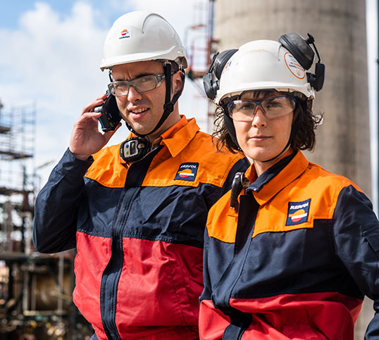 Two operators at a complex wearing PPE