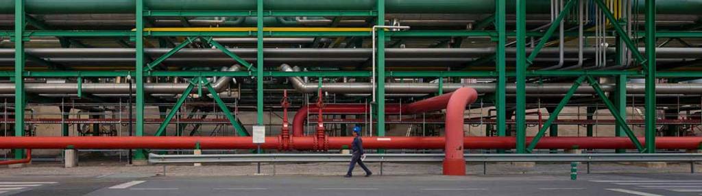 A person walking in a refinery