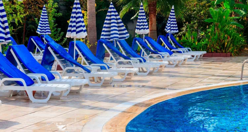 Swimming pool with deck chairs