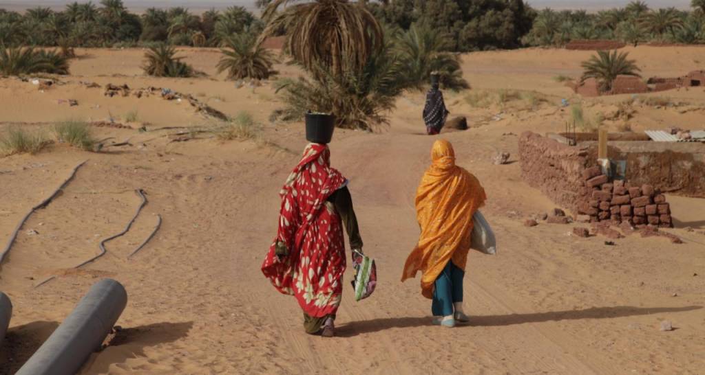 Two women walking in the desert