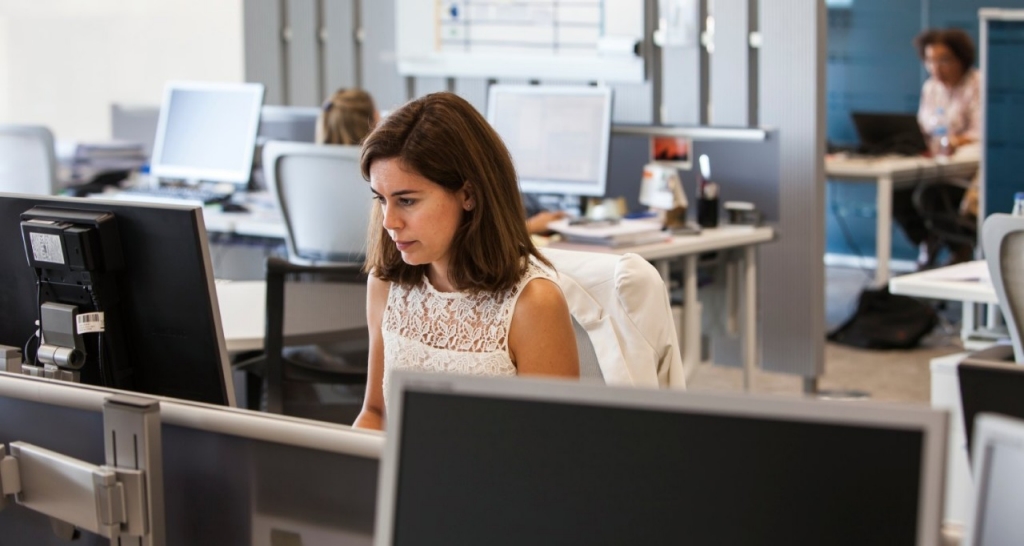 Woman talking on the phone at her office desk