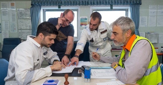 Various workers looking at documents