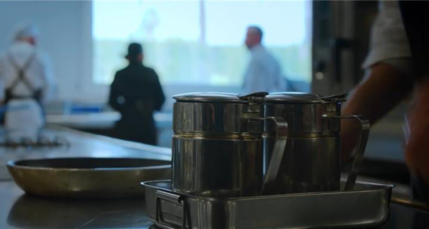 Used oil cans in a kitchen.
