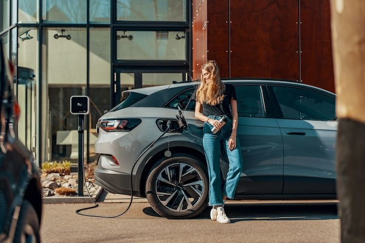 Woman charging electric car