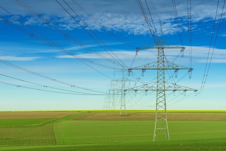 A green field and transmission towers